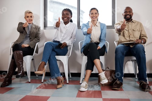 Preview: Shot of a group of businesspeople showing thumbs up while waiting in a line in a modern office