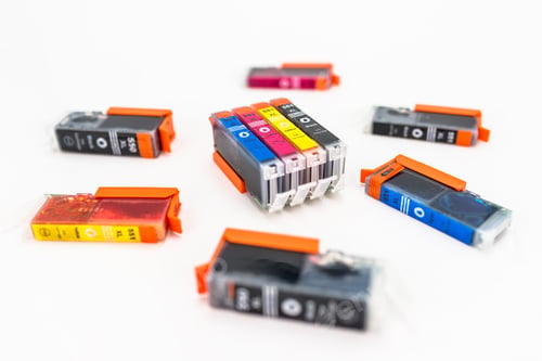Preview: Close-up shot of a CMYK ink cartridges for a color printer isolated on a white background. printer