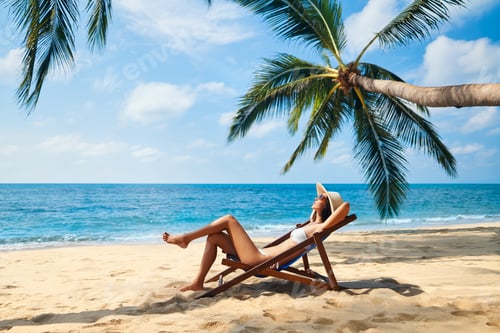 Preview: Young beautiful woman sunbathe and relax on tropical beach
