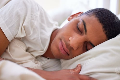 Preview: Cropped shot of a handsome young man sleeping in bed during the early hours of the morning at home