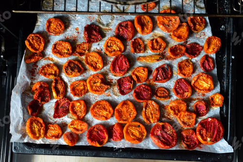 Preview: Trays of fresh cherry tomatoes on racks drying in the oven