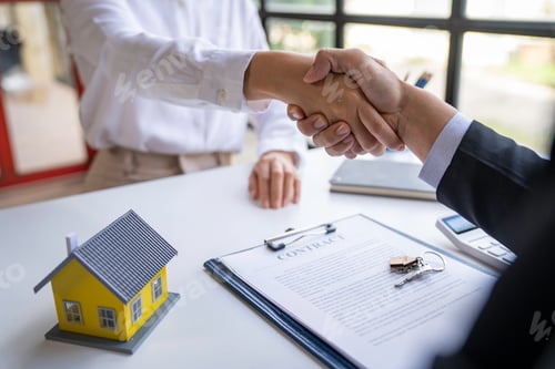 Preview: The estate agent and client are shaking hands after a good deal home loan after discussing and signi