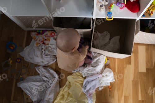 Preview: Caucasian baby playing with toys scattering them aroung.
