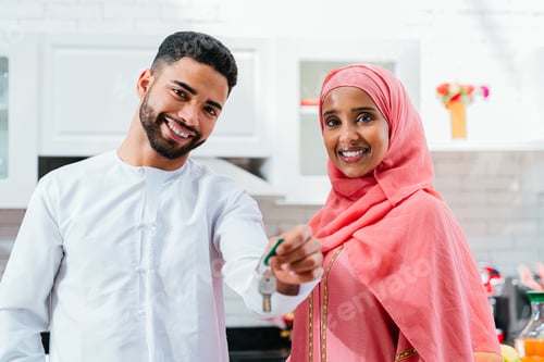 Preview: Cheerful Couple Holding Keys to New Home