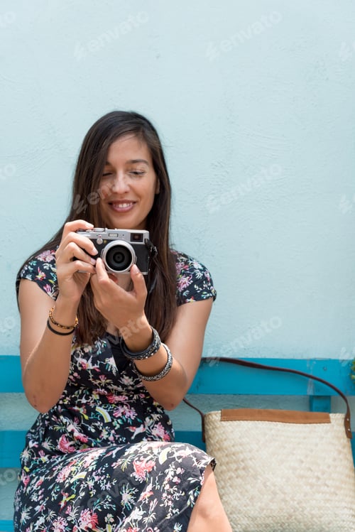 Preview: Woman in a dress in front of a colorful wall in Mexico