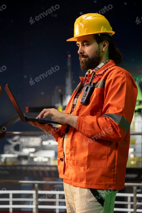 Preview: Industrial drilling barge crew member inspect equipment integrity using laptop