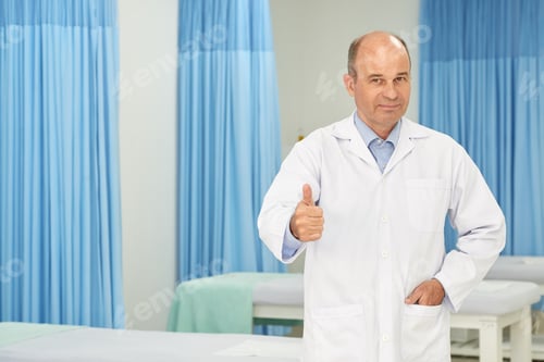 Mature Man Giving Thumbs Up in Hospital Room