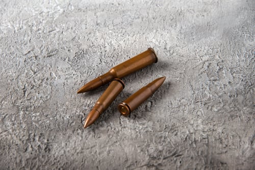 Preview: front view of brown bullets on white surface tank war death soldier guns