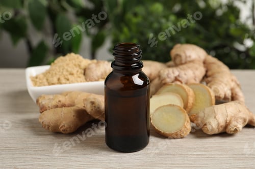 Preview: Ginger essential oil in bottle on light wooden table