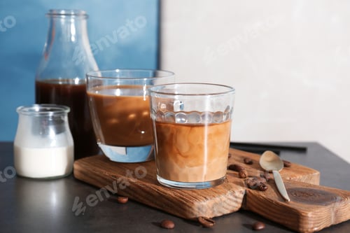 Preview: Glasses with cold brew coffee and milk on wooden board
