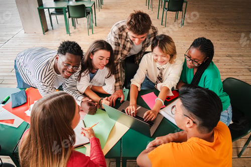 Preview: Big group of multiracial teenage students working together on the homework at the high school