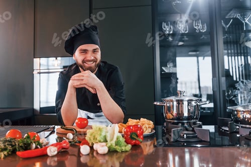 Preview: Preparing process. Professional young chef cook in uniform working on the kitchen