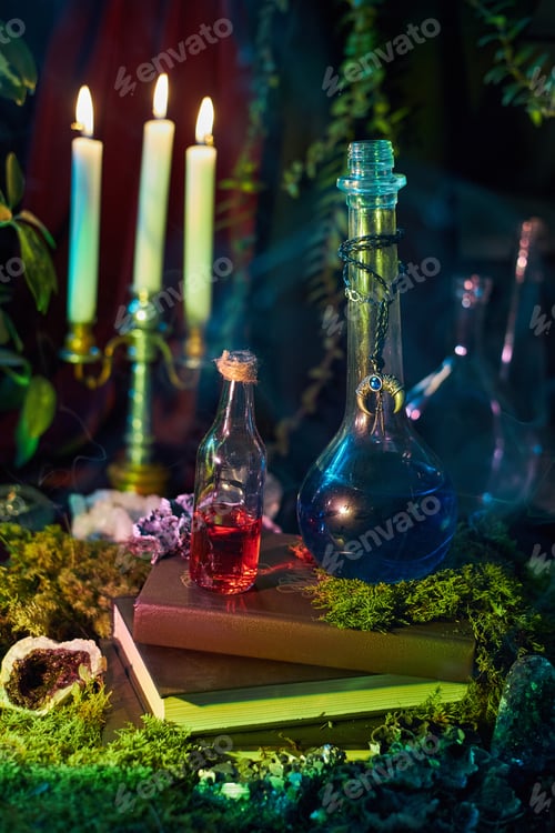 Preview: Colorful glass bottles filled with potions rest on a stack of books surrounded by candles