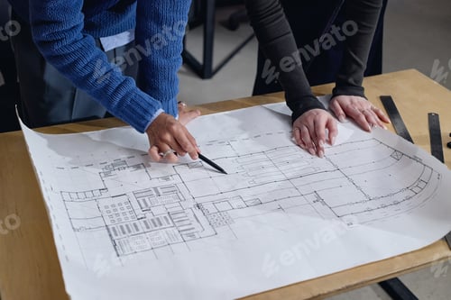 Preview: Middle Aged Black Man and Young Adult Woman Discussing Architectural Blueprint
