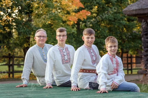 Preview: family: dad, sons in folk shirts on a farm in the countryside in summer