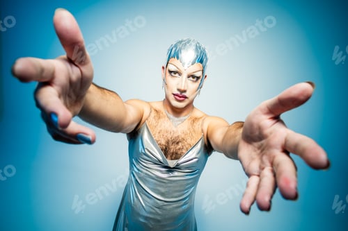 Preview: Latin Drag Queen Poses Elegantly in Studio With Outstretched Hands