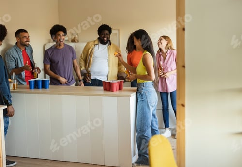 Preview: Group of diverse young people partying at home playing around having fun
