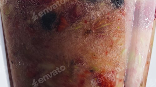 Preview: Closeup rotation blending fruits berries inside blender in super slow motion.