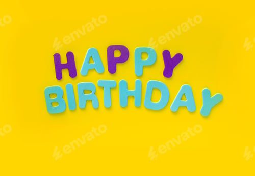 Preview: Happy Birthday colored words on yellow background with copy space.
