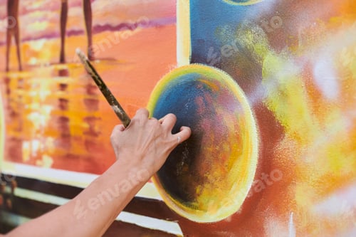 Preview: Female painter hand draws picture with paintbrush on canvas for exhibition, close up view