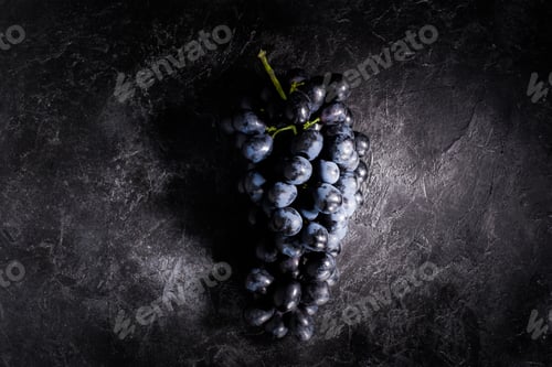 Preview: top view of bunch of fresh ripe grapes on black scratched surface