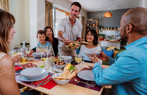 Preview: Family and friends reunion at home. Diverse family gathering enjoying dinner at home