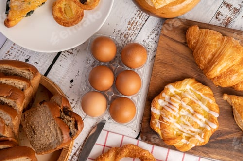 Preview: Various breads and eggs on red white cloth. Selective focus.