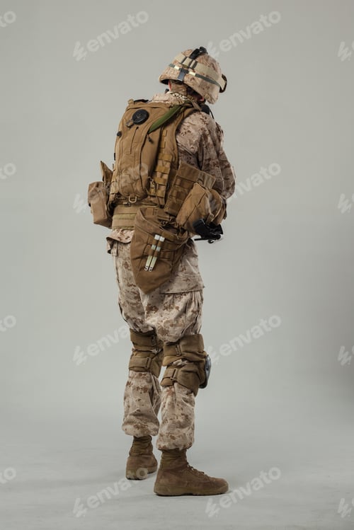 Preview: Military soldier wearing gear and equipment in a studio setting with 5G internet connection