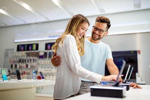 Preview: Shopping a new digital device. Happy couple buying a smartphone in store.