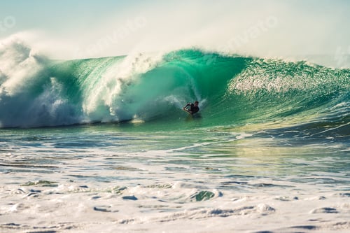Preview: man surfing a powerful and big wave at sunset