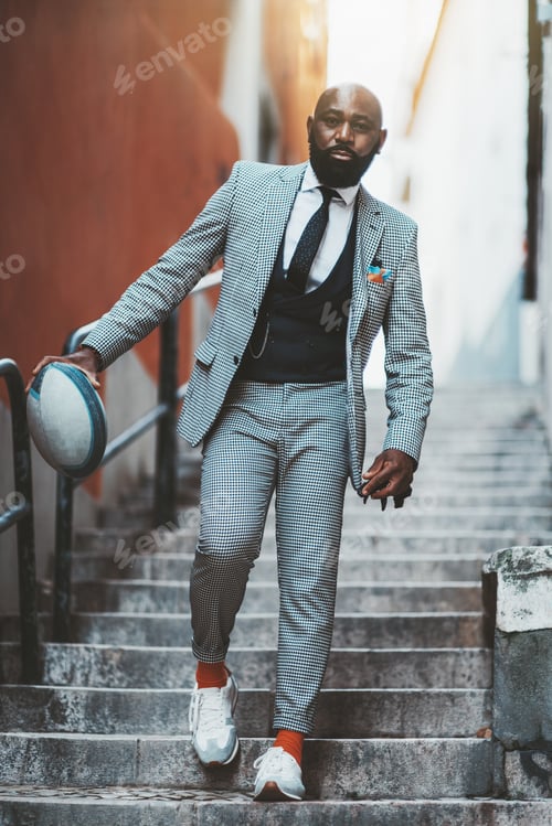 Preview: A black elegant guy with a football