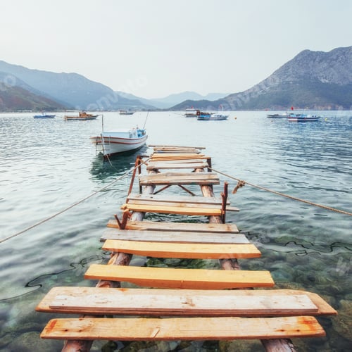 Preview: Boats near the broken pier, putting in a tranquil calm blue sea water