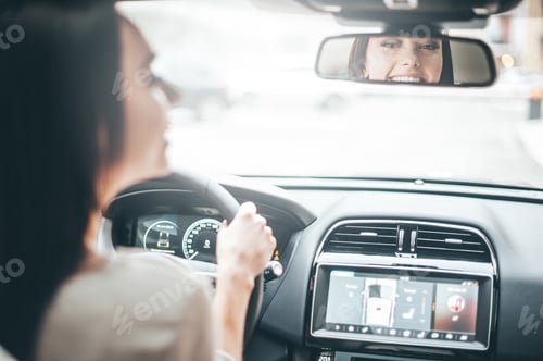 Preview: Driver in rear-view mirror.