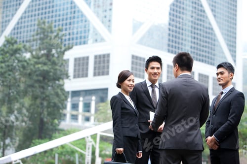 Preview: Cheerful business persons discussing with each other in Hong Kong