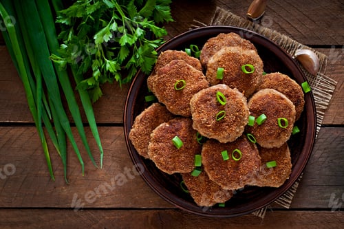 Preview: Juicy delicious meat cutlets on a wooden table in a rustic style.
