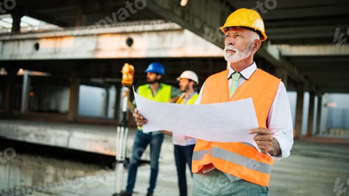 Preview: Engineer and construction site manager dealing with blueprints and plans