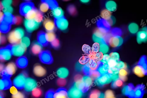 Preview: Colorful lights bokeh from decorative luminous flowers garlands at holiday, multicolored lights