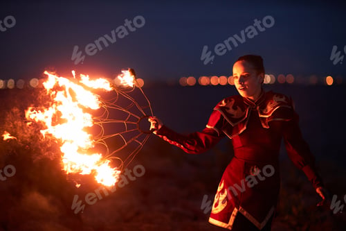 Preview: Female performer dancing with fire fans