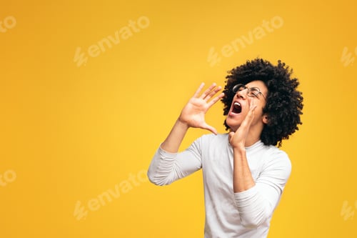 Preview: Young african-american man yelling on orange background