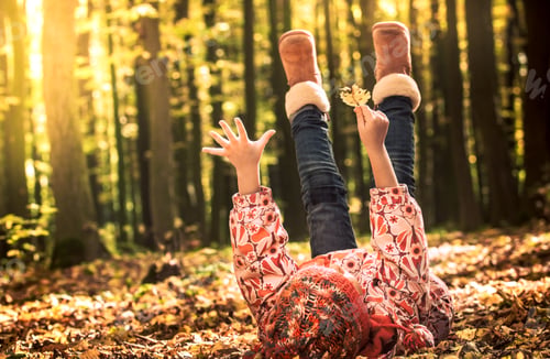Preview: little girl playing in autumn leaves