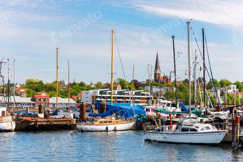 Preview: Scenic view fishing boats vessel docked Flensburg marina harbor, architectural silhouettes church