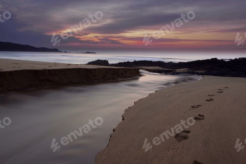 Preview: Scenic Beach Landscape with Footprints at Sunset