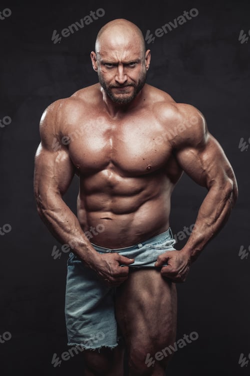 Preview: Angry bald bodybuilder pulling his shorts showing his muscular leg