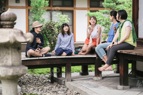 Preview: Group of japanese tourists using a tablet