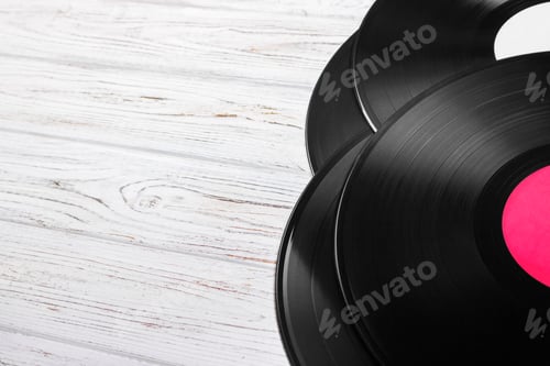 Preview: Top view of vinyl records stack over light wooden table with copy space for text