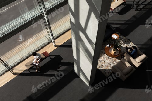 Preview: High angle view of young multi-ethnic business executive working in modern office