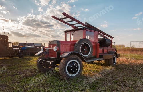 Preview: Old retro fire truck with wooden case on the field