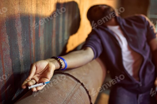 Preview: Drug addict man with syringe in high