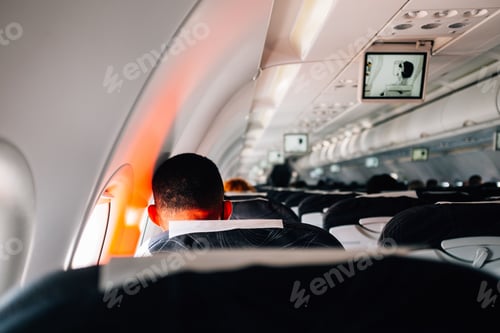 Preview: Back of people's heads as they wait for takeoff on a commercial airplane.