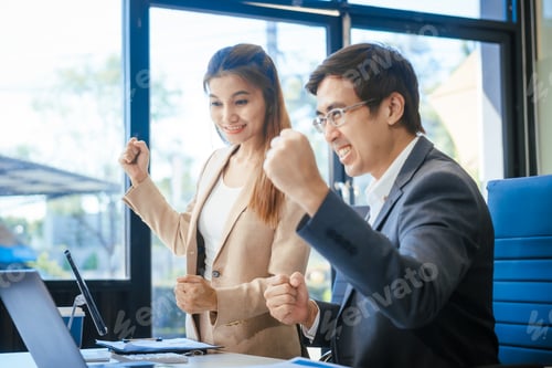 Preview: A businessman and woman sit at a modern office table, smiling discussing a new project or business